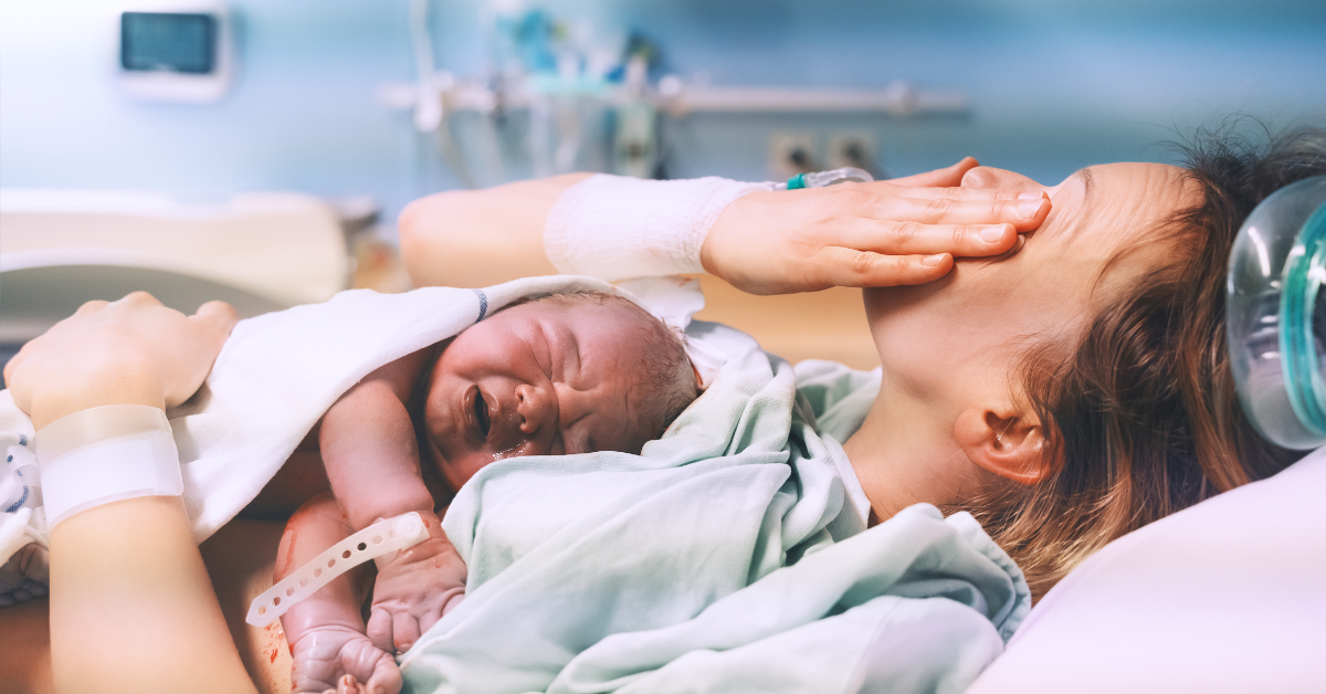 Woman holding her newborn baby after labor